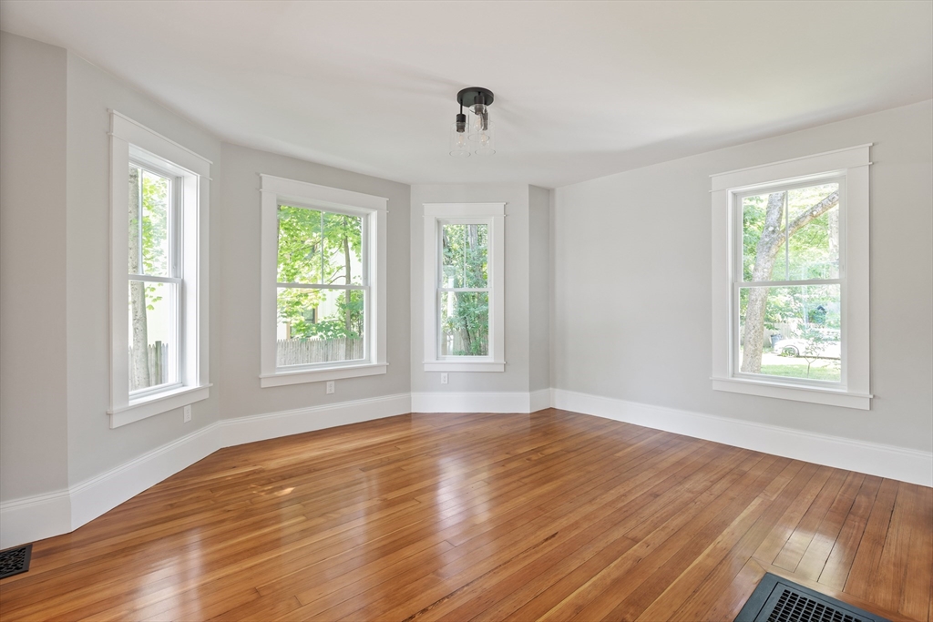 8 Florence Street Natick, MA 01760 - Photo 19 of 38 a view of an empty room with wooden floor and a window