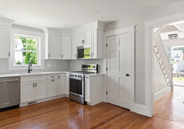a kitchen with a refrigerator sink and cabinets