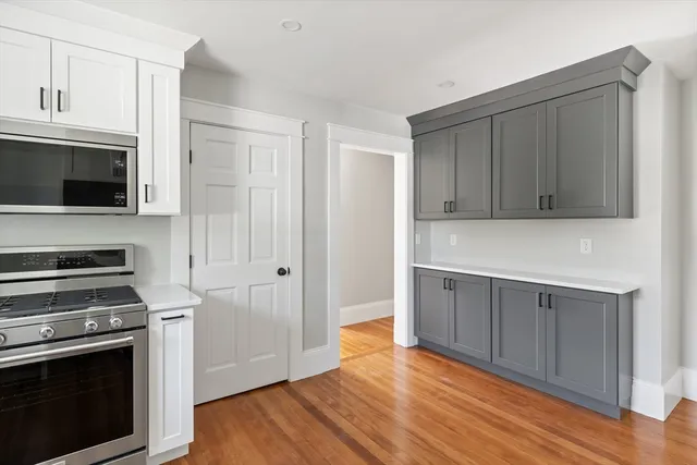 a kitchen with stainless steel appliances a white cabinets and sink