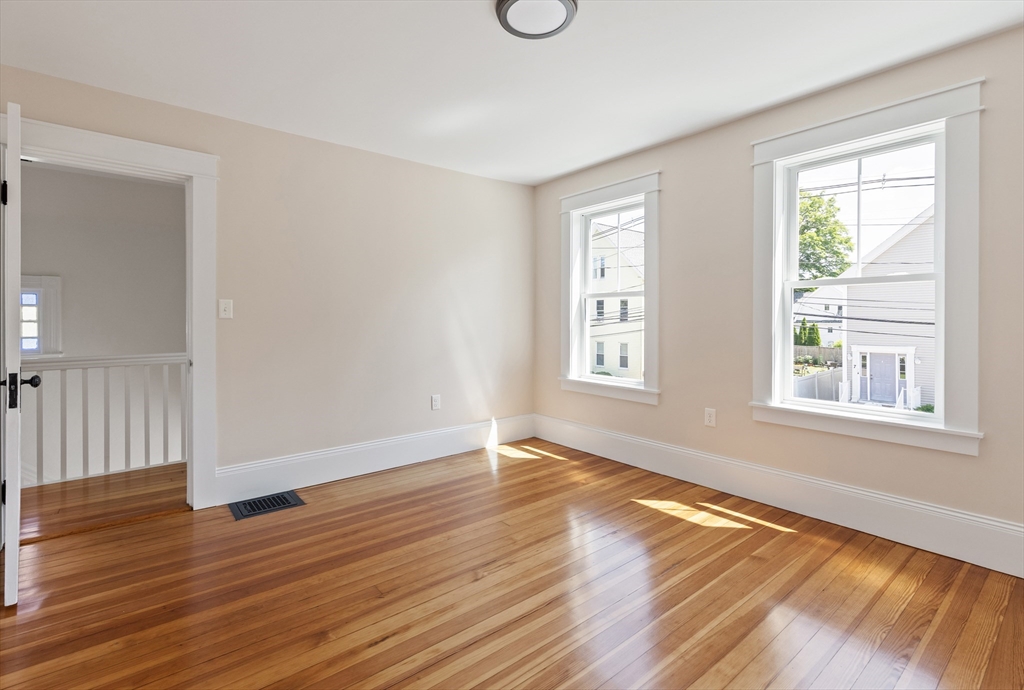 8 Florence Street Natick, MA 01760 - Photo 33 of 38 an empty room with wooden floor and windows