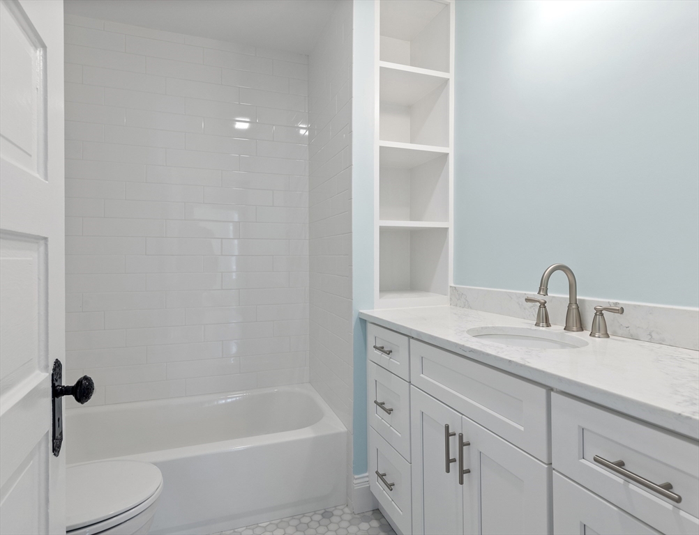 8 Florence Street Natick, MA 01760 - Photo 36 of 38 a bathroom with a granite countertop sink a toilet and bathtub
