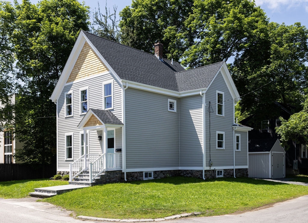 8 Florence Street Natick, MA 01760 - Photo 5 of 38 a view of a yard in front of a house with plants and large tree
