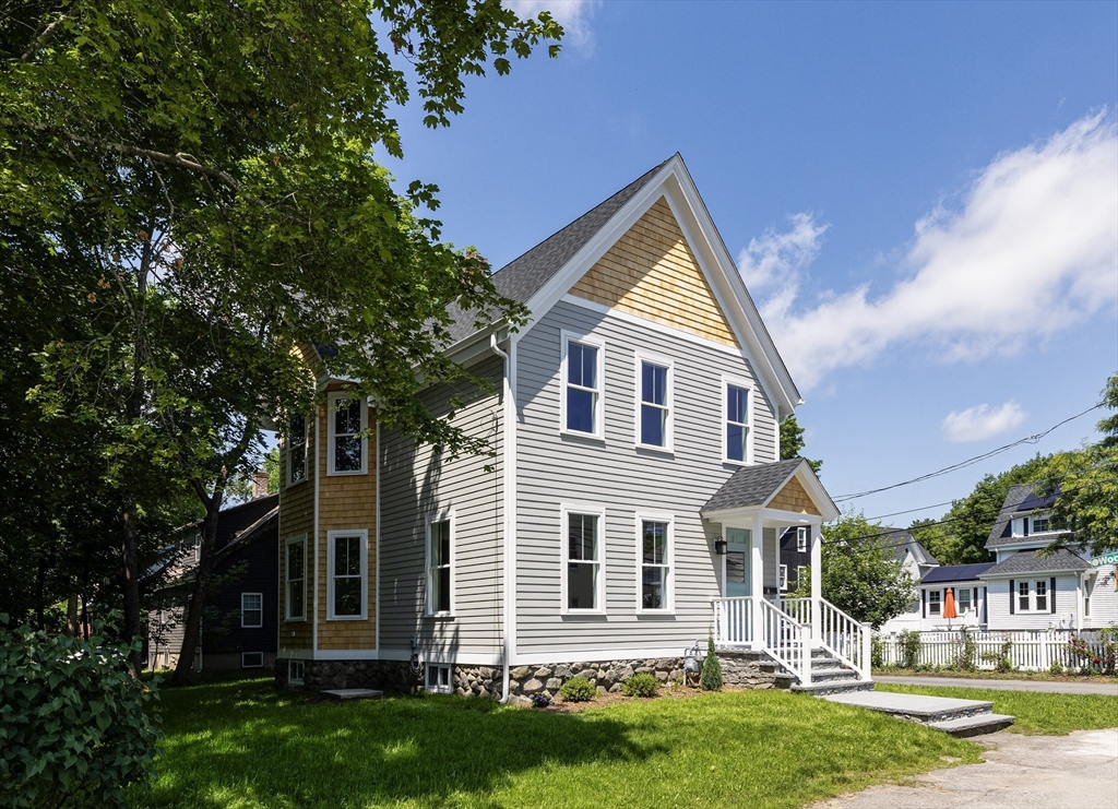 8 Florence Street Natick, MA 01760 - Photo 9 of 38 a front view of a house with a yard