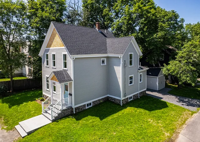 a view of backyard with deck and garden