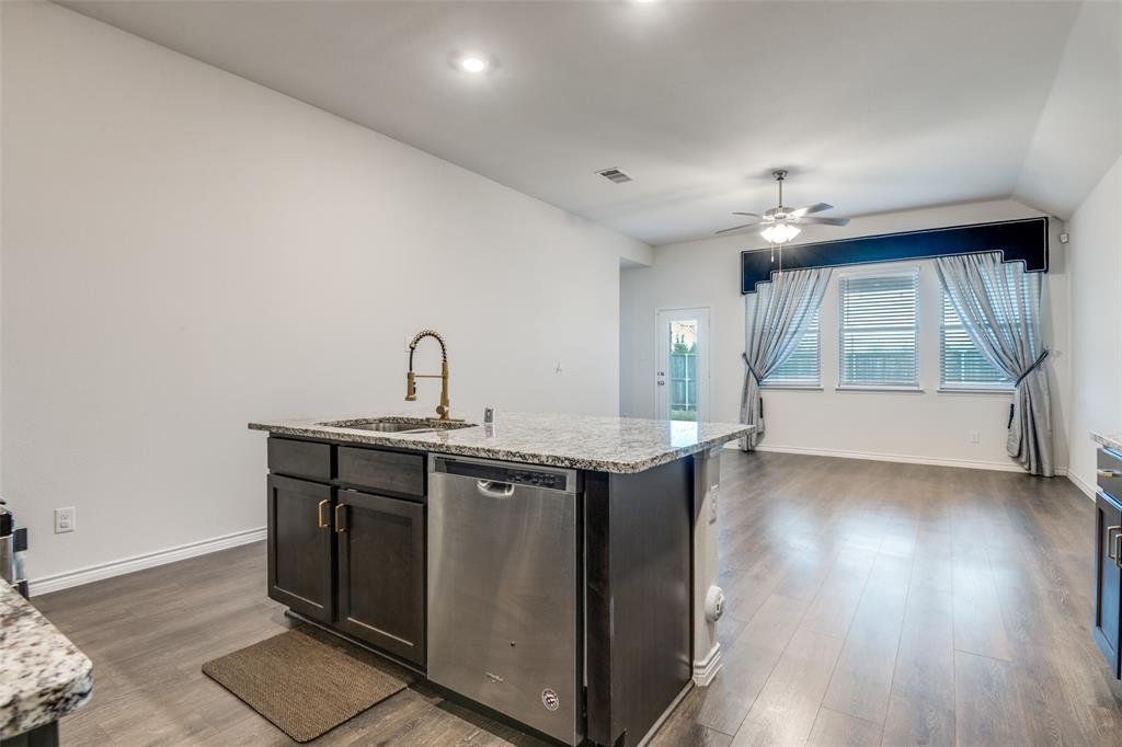 905 Philadelphia Street Fate, TX 75189 - Photo 12 of 25 a kitchen with a sink cabinets and wooden floor