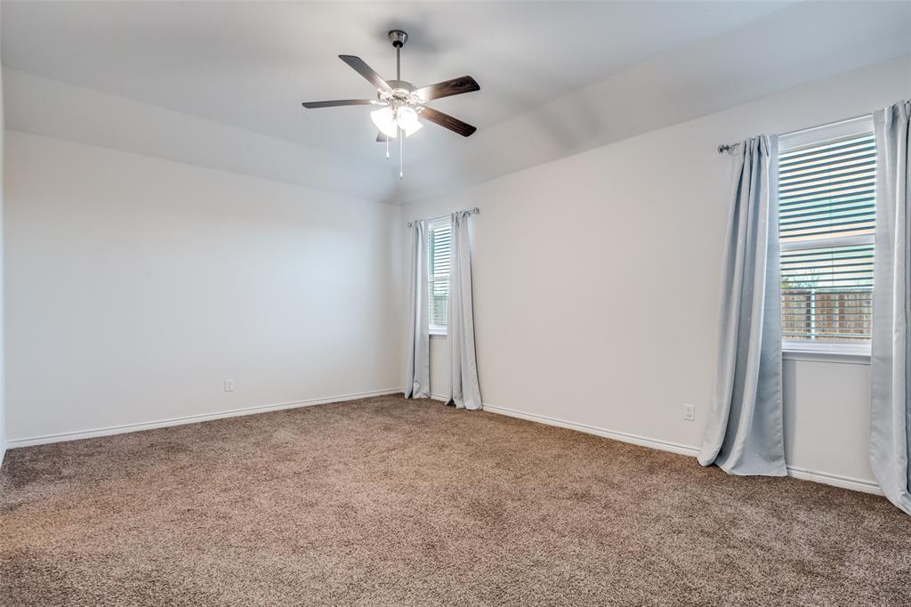 905 Philadelphia Street Fate, TX 75189 - Photo 18 of 25 an empty room with a chandelier fan and windows