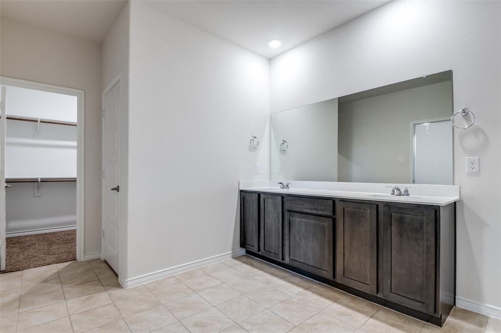 905 Philadelphia Street Fate, TX 75189 - Photo 20 of 25 a bathroom with a sink and a mirror