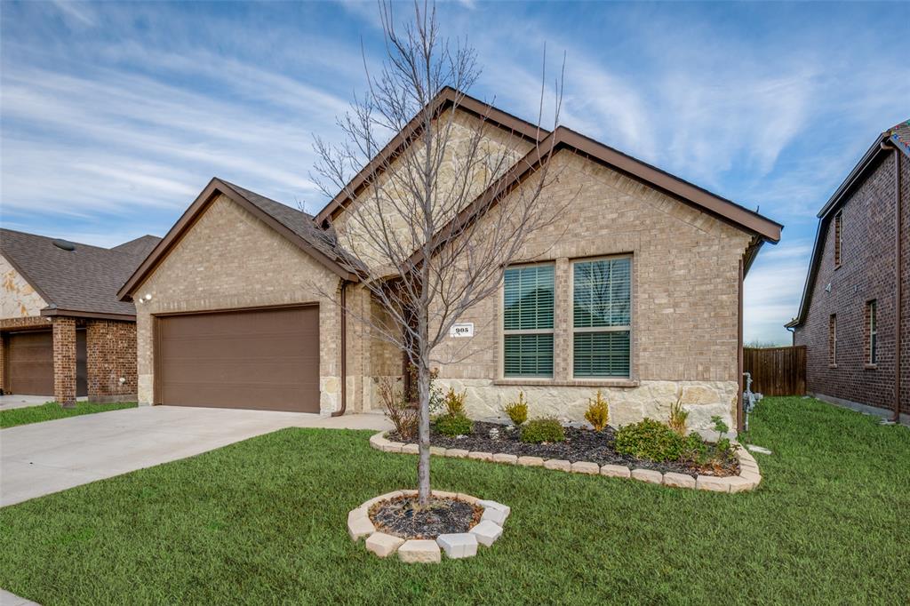 905 Philadelphia Street Fate, TX 75189 - Photo 2 of 25 a front view of a house with a yard and garage