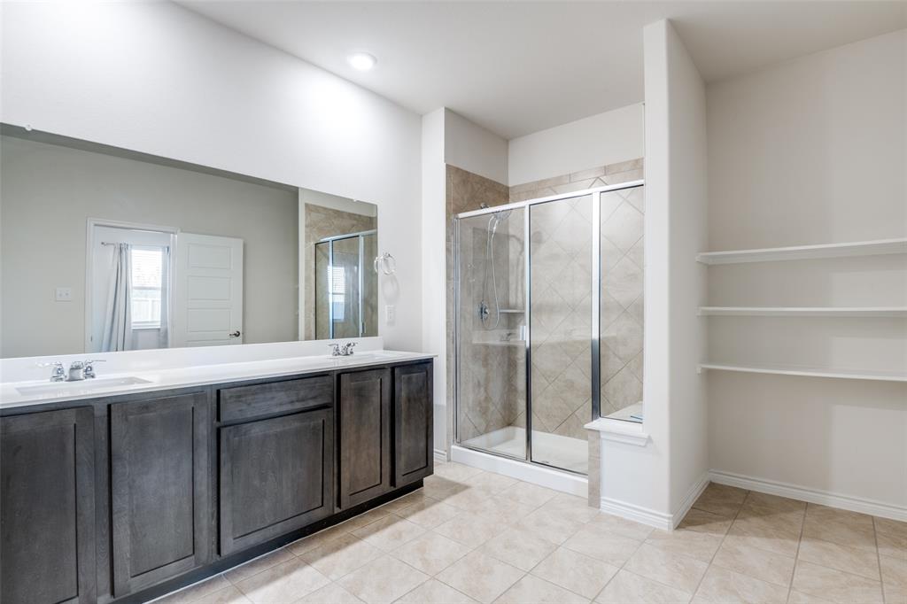 905 Philadelphia Street Fate, TX 75189 - Photo 21 of 25 a spacious bathroom with a shower sink and mirror