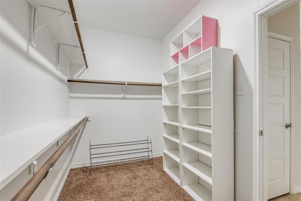 905 Philadelphia Street Fate, TX 75189 - Photo 22 of 25 a view of walk in closet with empty racks