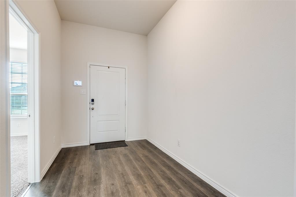 905 Philadelphia Street Fate, TX 75189 - Photo 4 of 25 a view of a small space with wooden floor and a window