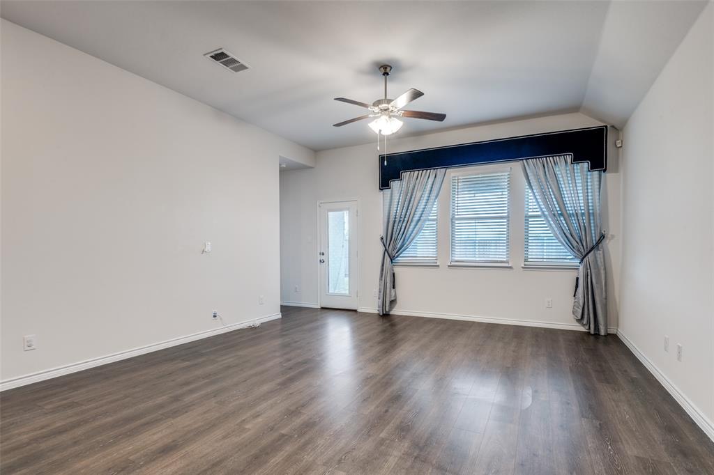905 Philadelphia Street Fate, TX 75189 - Photo 5 of 25 a view of an empty room with wooden floor and a window