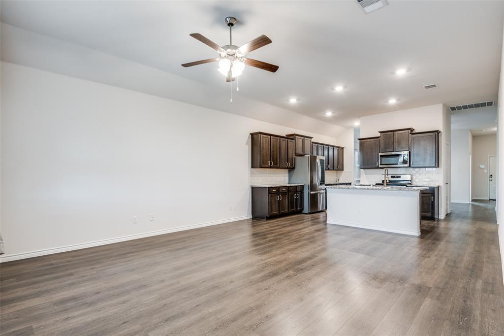 905 Philadelphia Street Fate, TX 75189 - Photo 8 of 25 a view of kitchen with refrigerator microwave and stove