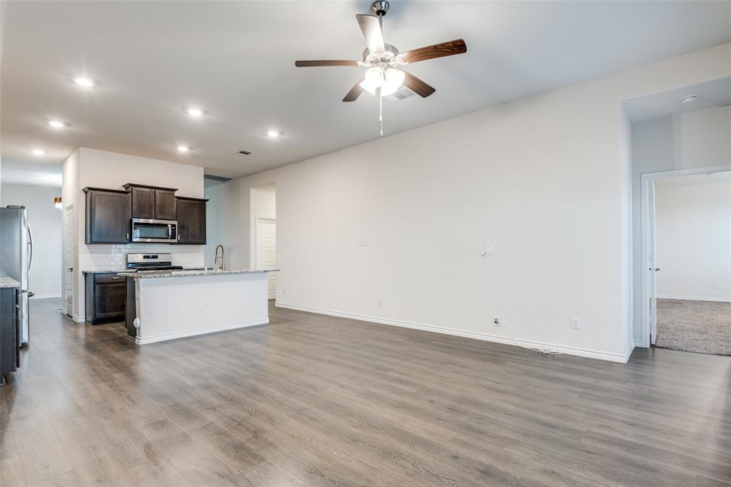905 Philadelphia Street Fate, TX 75189 - Photo 9 of 25 a view of kitchen with microwave oven stove refrigerator and cabinets