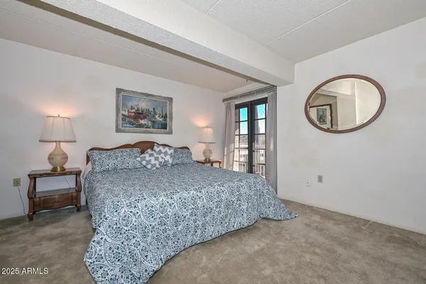 a bedroom with a bed and a chandelier
