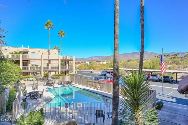 a view of a city from a patio with swimming pool