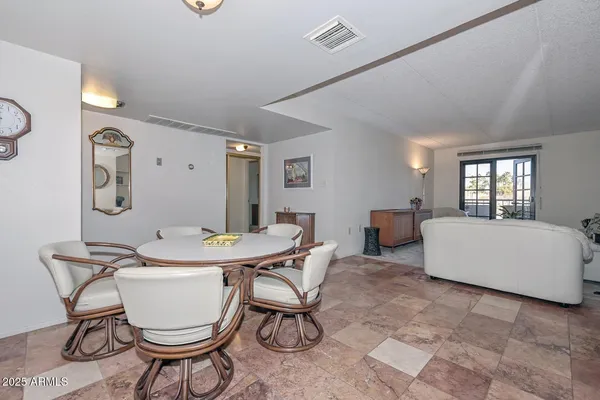 a living room with furniture a table and chair