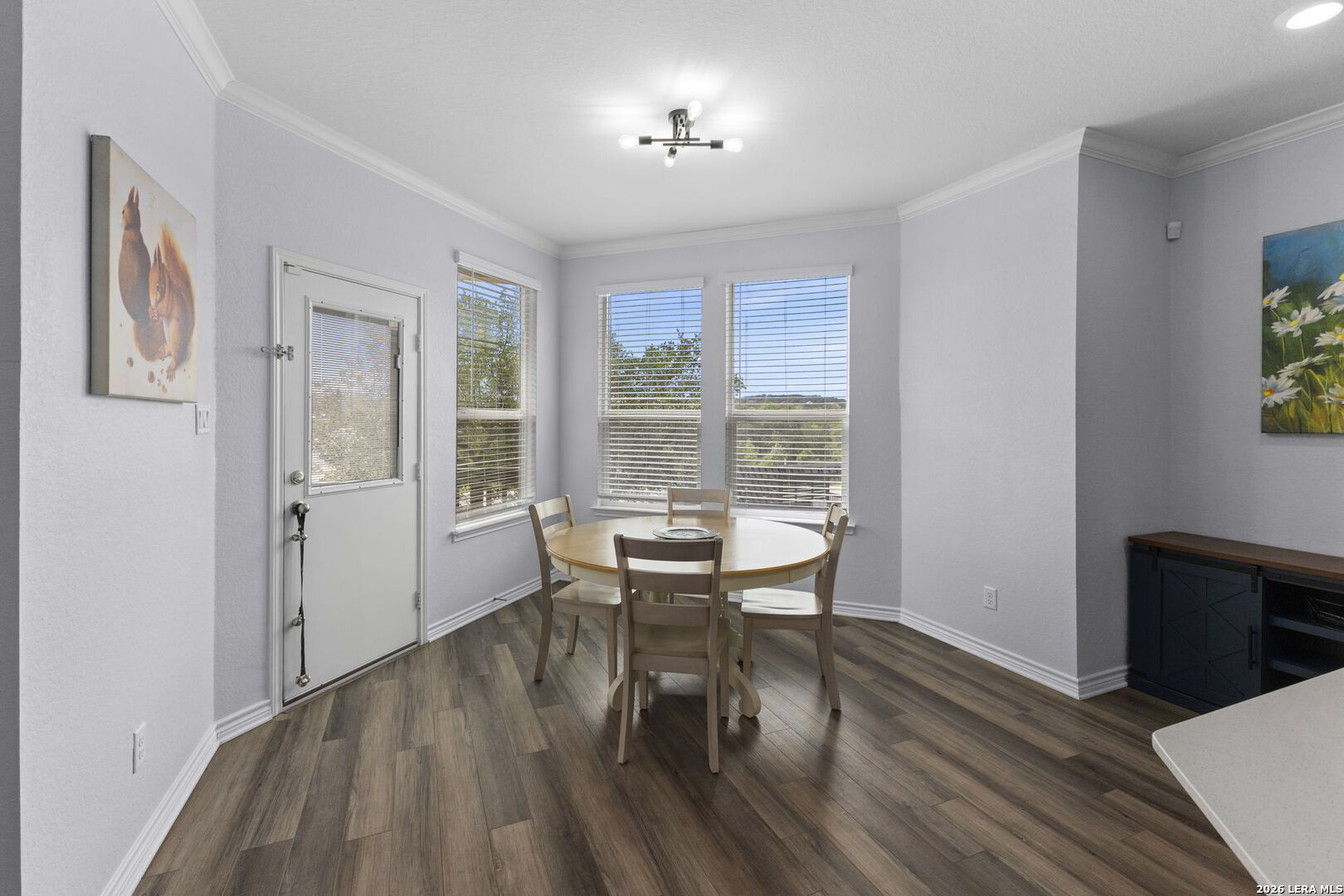 29985 Sebastian Bulverde, TX 78163 - Photo 7 of 37 a dining room with wooden floor and a floor to ceiling window