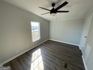 306 Dennard Road Unadilla, GA 31091 - Photo 11 of 14 an empty room with wooden floor and windows