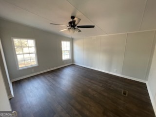 306 Dennard Road Unadilla, GA 31091 - Photo 12 of 14 an empty room with wooden floor fan and windows