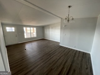 306 Dennard Road Unadilla, GA 31091 - Photo 4 of 14 a view of an empty room with wooden floor and a window