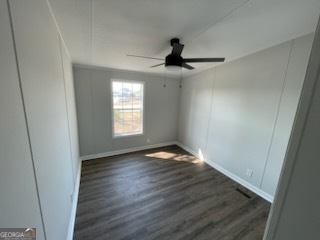 306 Dennard Road Unadilla, GA 31091 - Photo 10 of 14 a view of empty room with wooden floor and fan