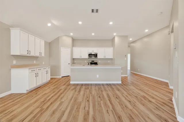 a view of kitchen with cabinets
