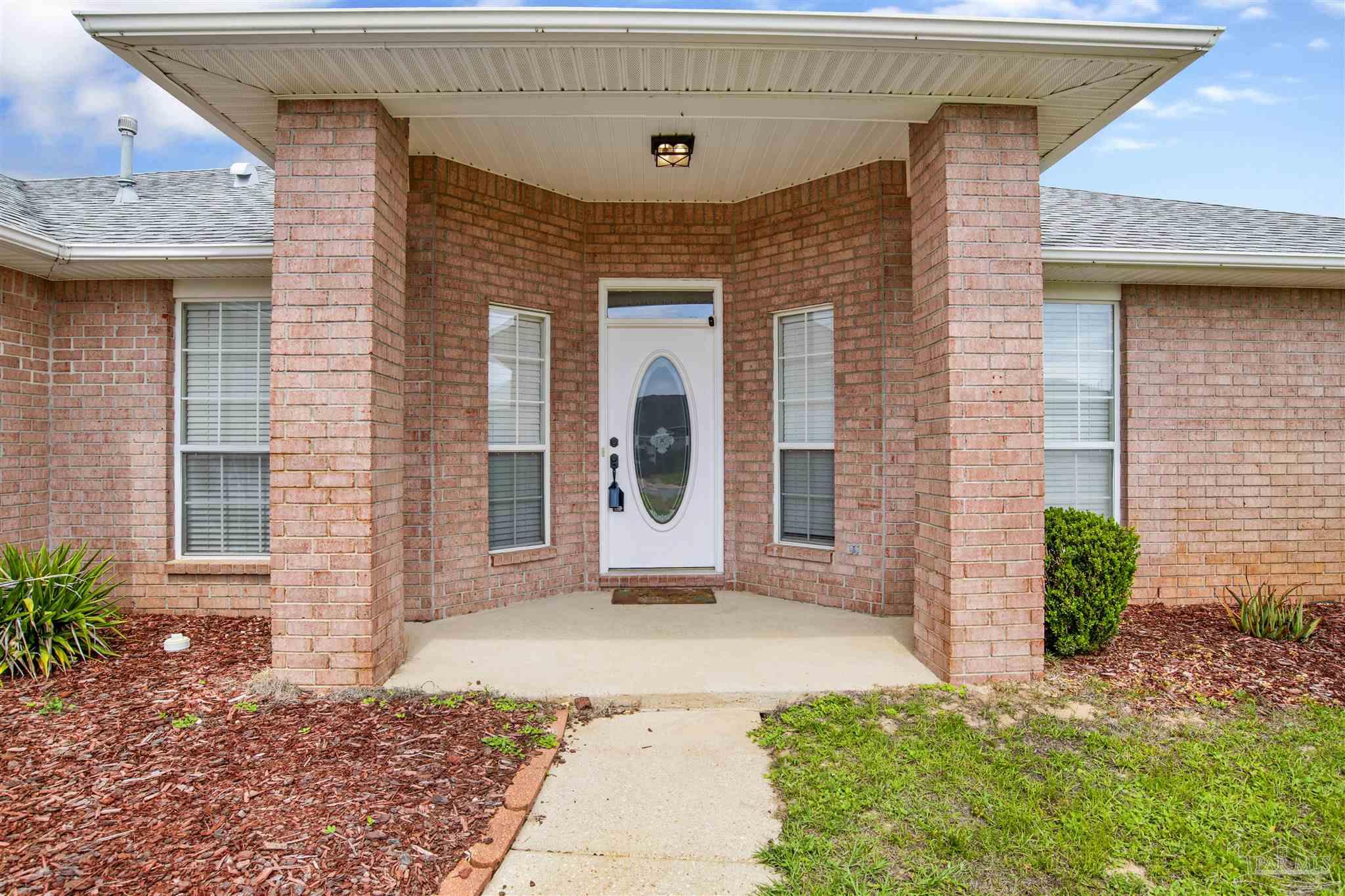 128 Gunwale Road Pensacola, FL 32507 - Photo 2 of 34 a front view of a house with garden