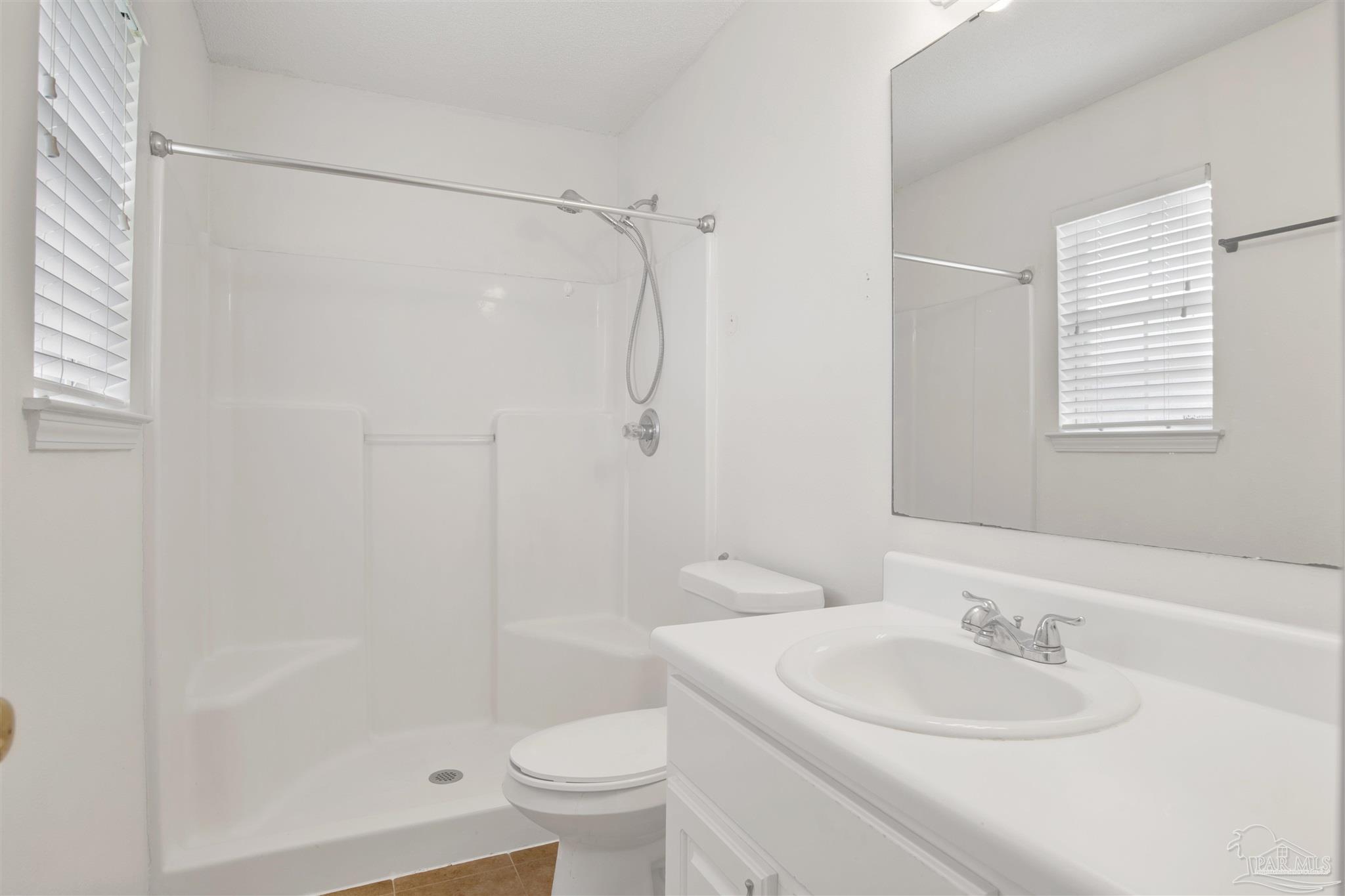 128 Gunwale Road Pensacola, FL 32507 - Photo 24 of 34 a bathroom with a sink a toilet and shower