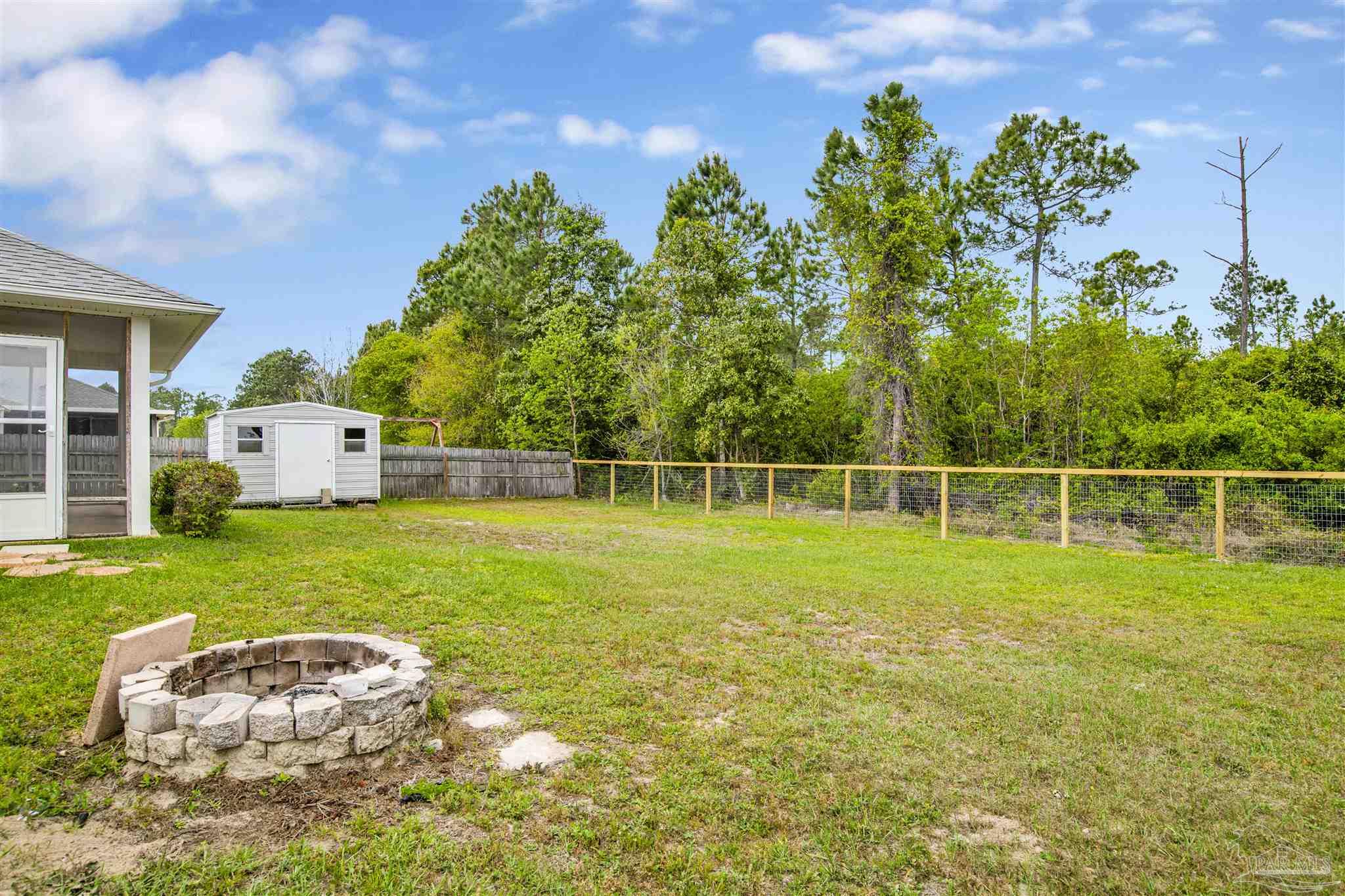 128 Gunwale Road Pensacola, FL 32507 - Photo 28 of 34 a house with green field in front of it
