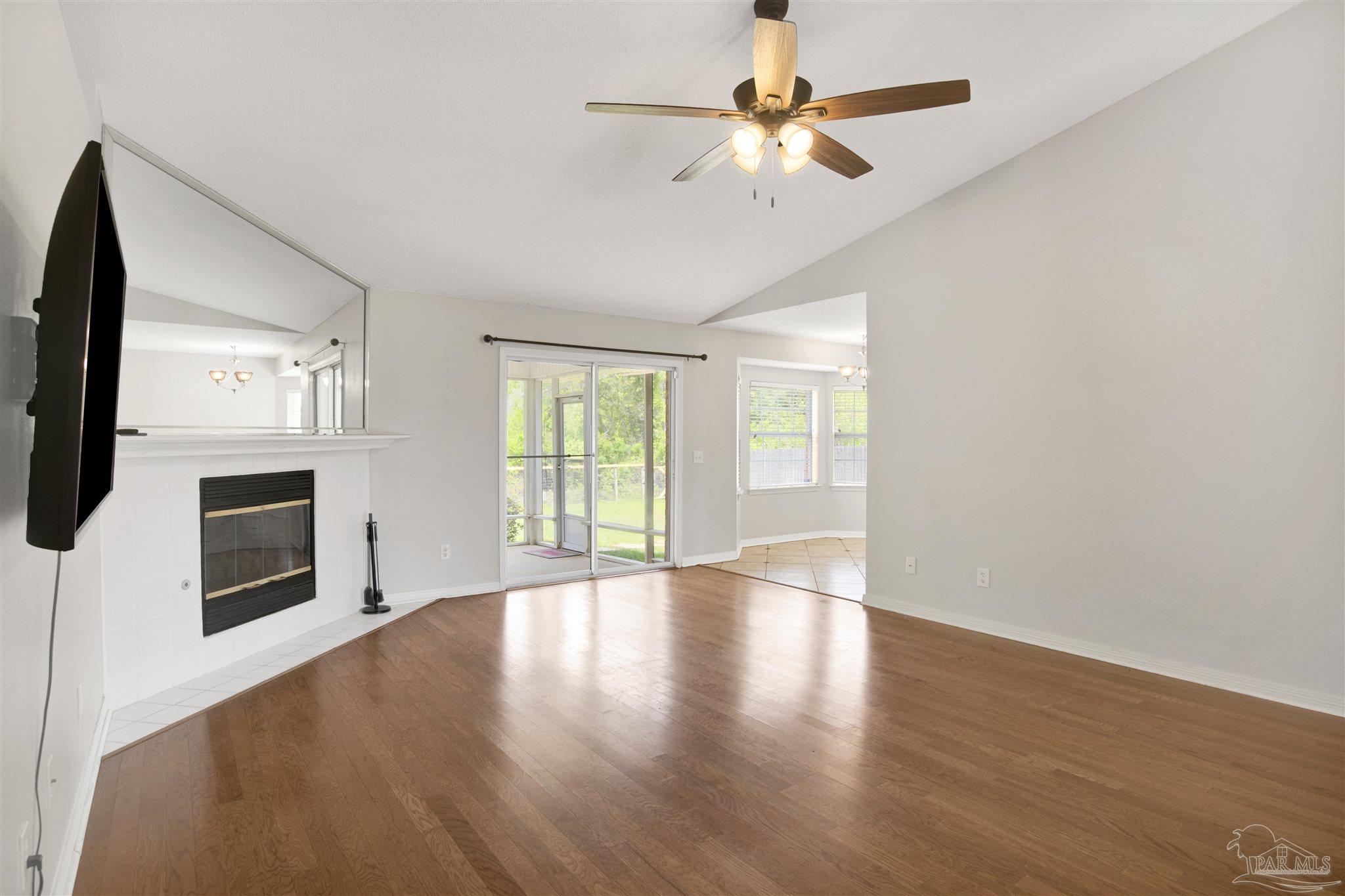 128 Gunwale Road Pensacola, FL 32507 - Photo 8 of 34 a view of an empty room with a fireplace and a window