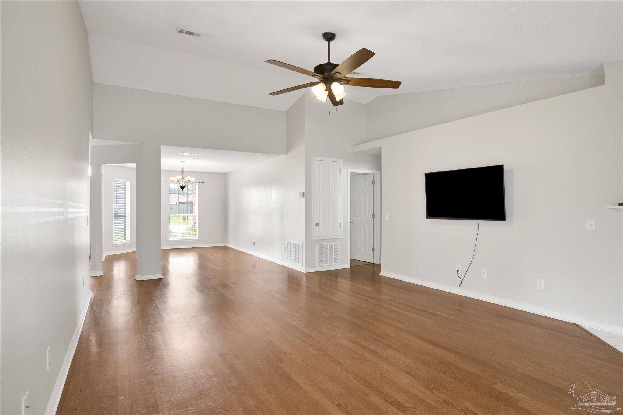 128 Gunwale Road Pensacola, FL 32507 - Photo 10 of 34 a view of an empty room with wooden floor and a ceiling fan