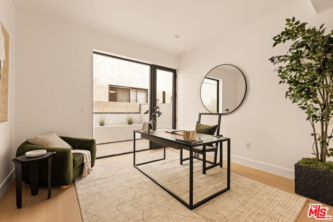 2425 20th Street, Unit B Santa Monica, CA 90405 - Photo 11 of 12 a living room with furniture a window and a potted plant