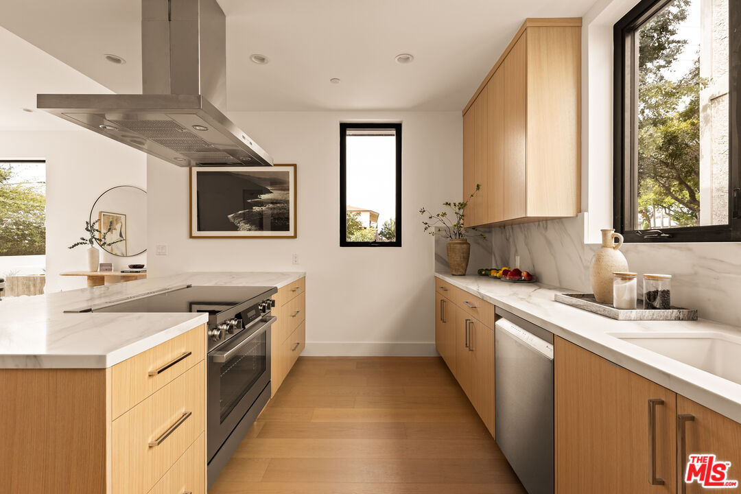 2425 20th Street, Unit B Santa Monica, CA 90405 - Photo 4 of 12 a kitchen with stainless steel appliances granite countertop a sink stove and cabinets