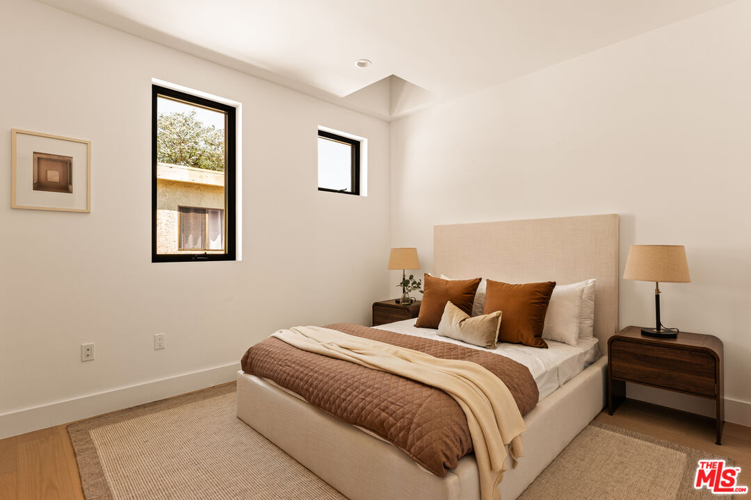 2425 20th Street, Unit B Santa Monica, CA 90405 - Photo 8 of 12 a bedroom with a bed and a window