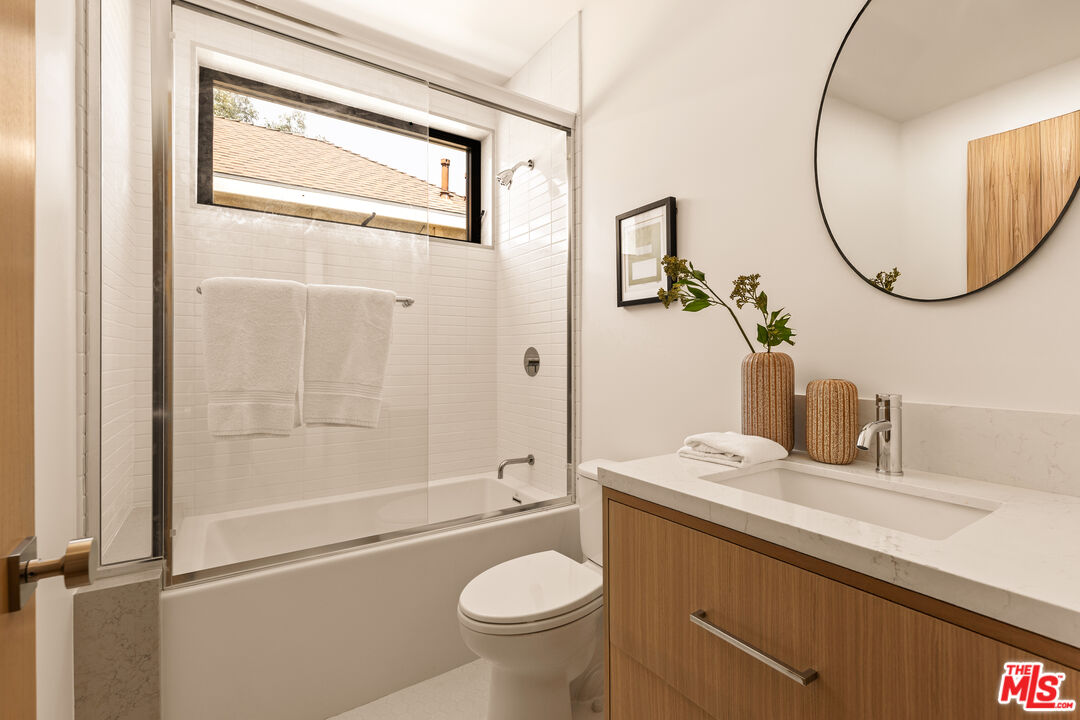 2425 20th Street, Unit B Santa Monica, CA 90405 - Photo 9 of 12 a bathroom with a sink a toilet and a mirror