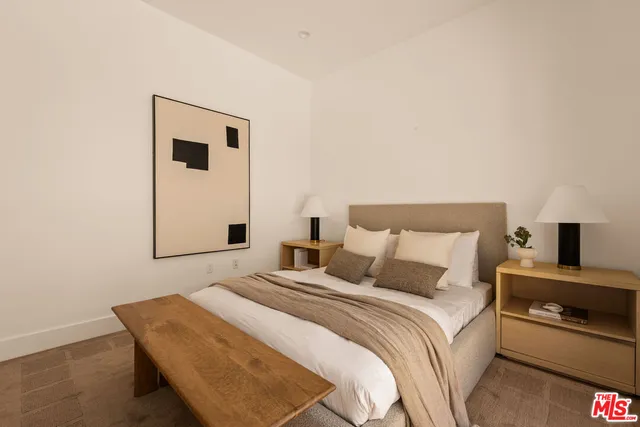 a bedroom with a bed and a night stand