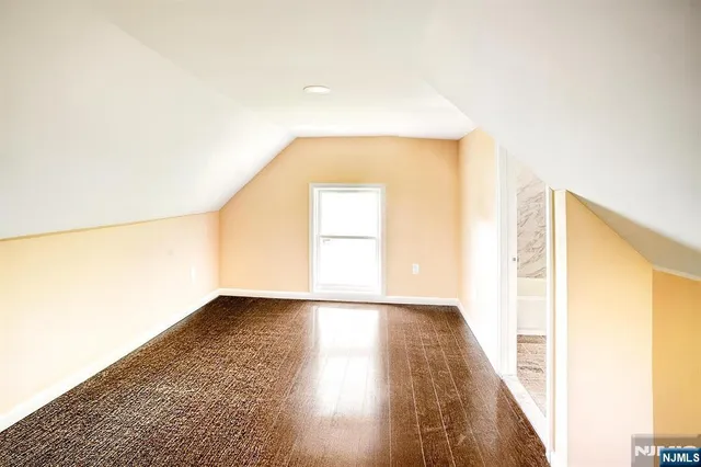 a view of an empty room and wooden floor