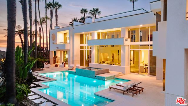 a view of a house with backyard porch and sitting area