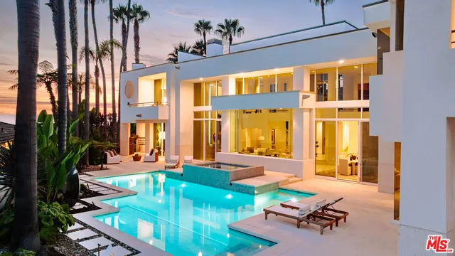 a view of a house with backyard porch and sitting area