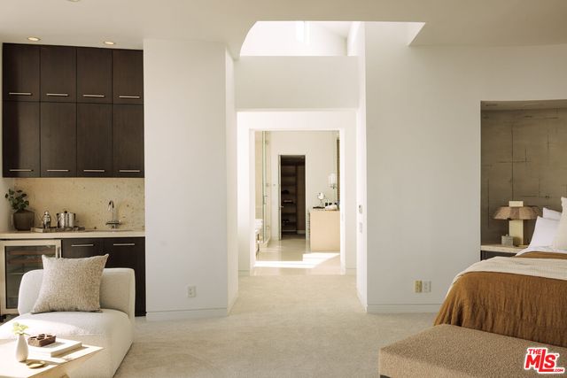 a bedroom with a bed and a mirror