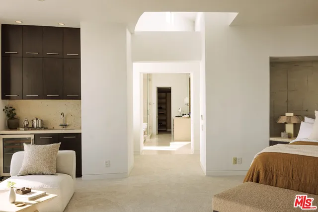 a bedroom with a bed and a mirror