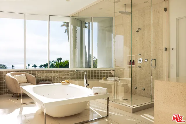 a bathroom with a bathtub and a shower