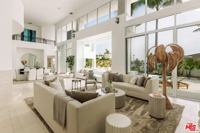 a living room with furniture fireplace and a large window