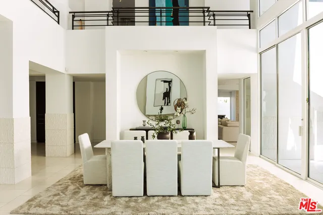 a living room with furniture and a mirror