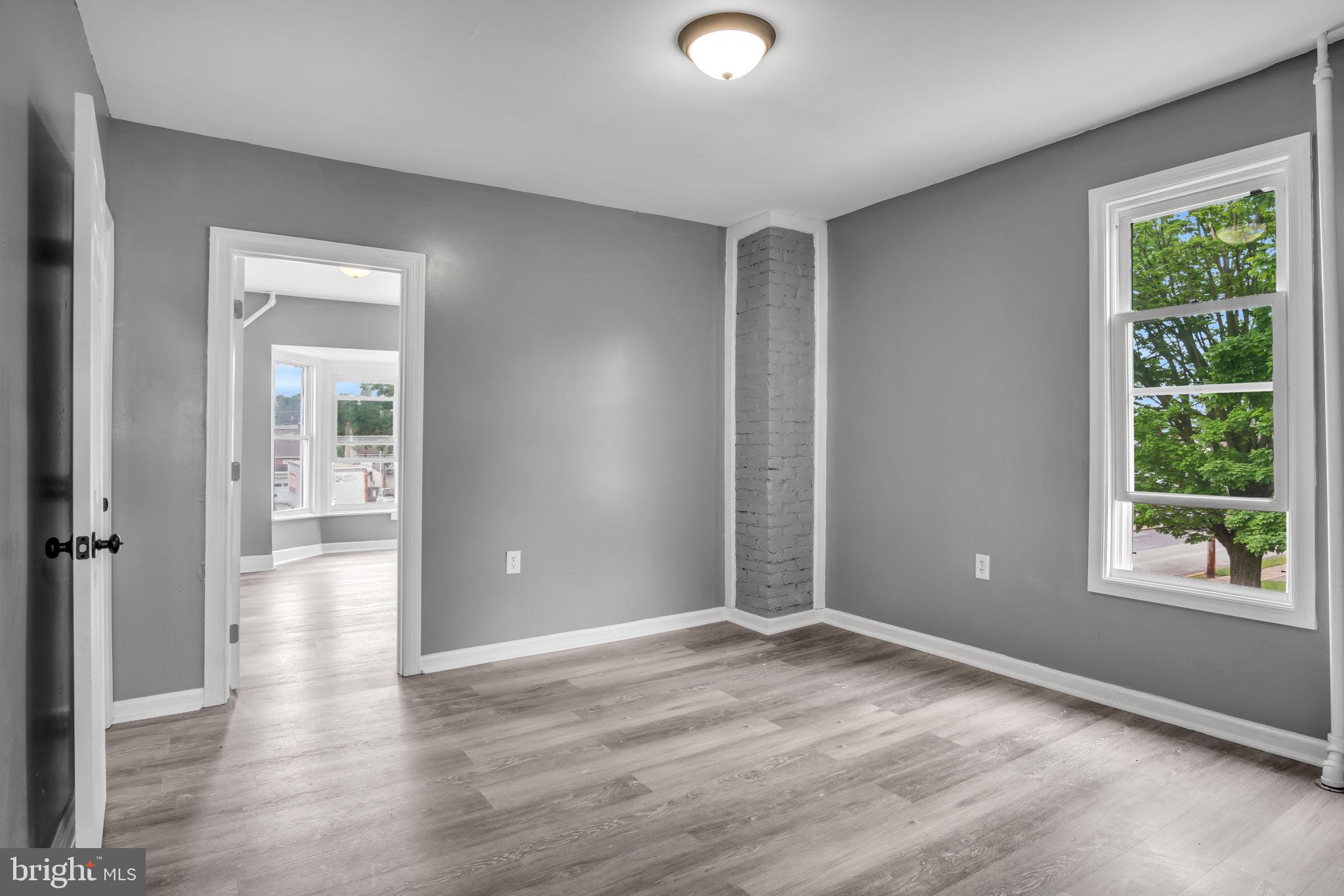 1426 Filbert Street, Unit 2 York, PA 17404 - Photo 12 of 17 wooden floor in an empty room with a window
