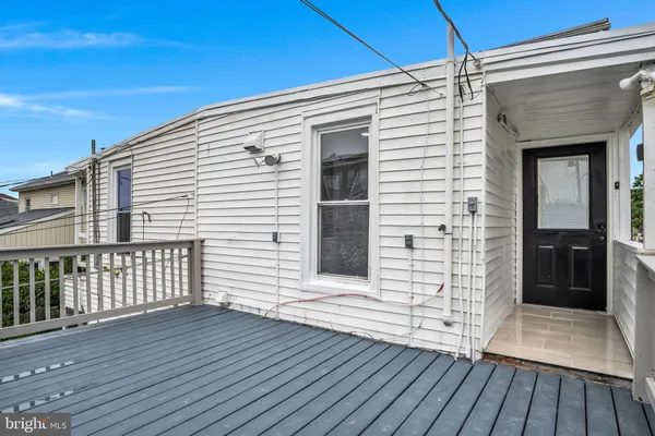 a view of a balcony with wooden floor and fence