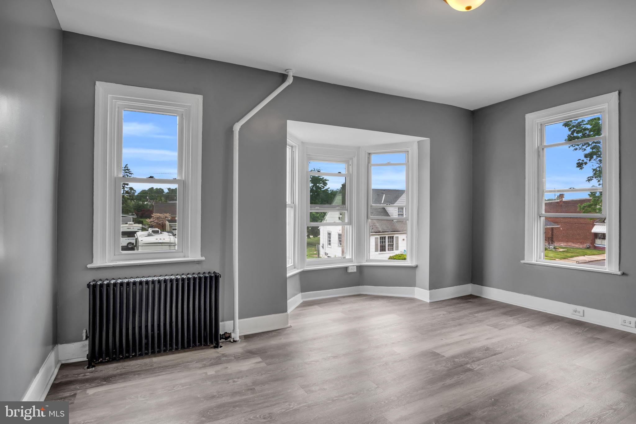 1426 Filbert Street, Unit 2 York, PA 17404 - Photo 7 of 17 an empty room with wooden floor and windows