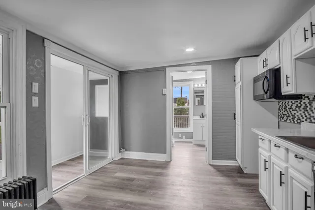 a view of a kitchen with wooden floor and a sink