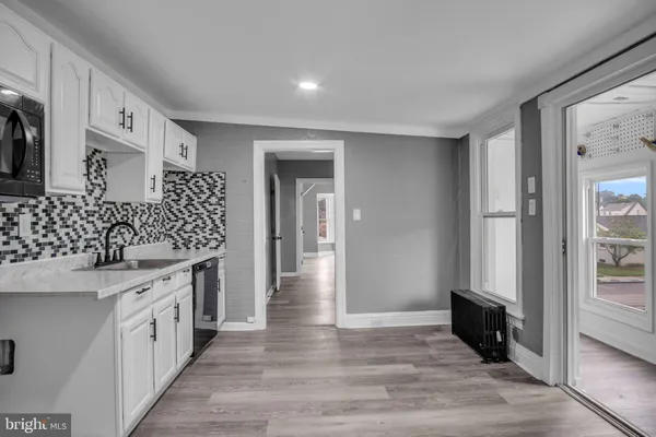 a kitchen with granite countertop a sink and cabinets